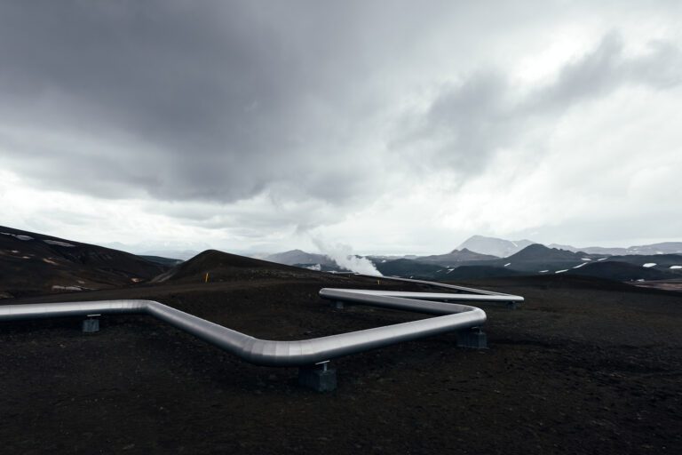 Iceland landscape with pipes in mountains. Geothermal energy in operations renewable energy