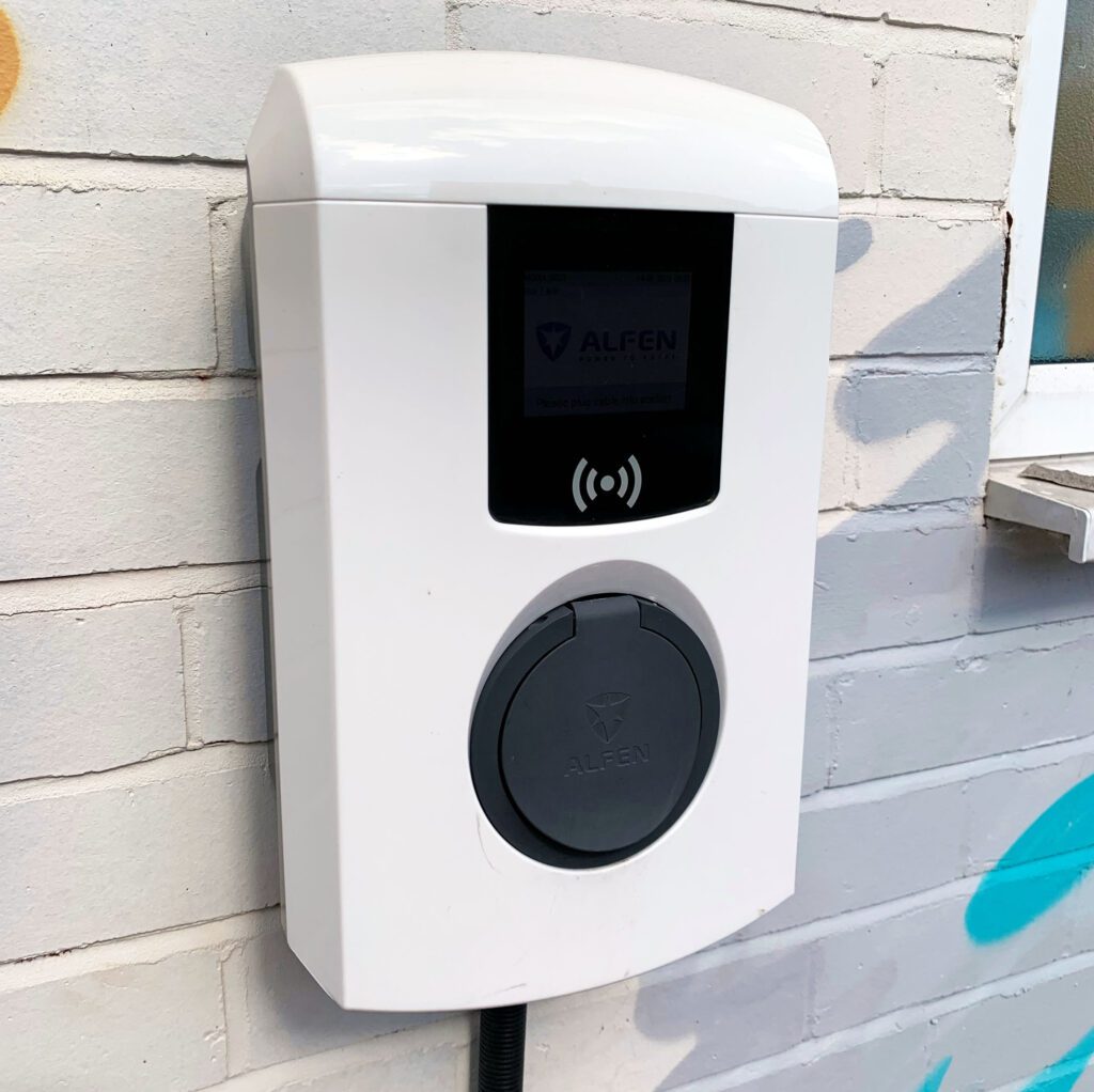 Alfen EV Charger installed on a wall on he side of a building