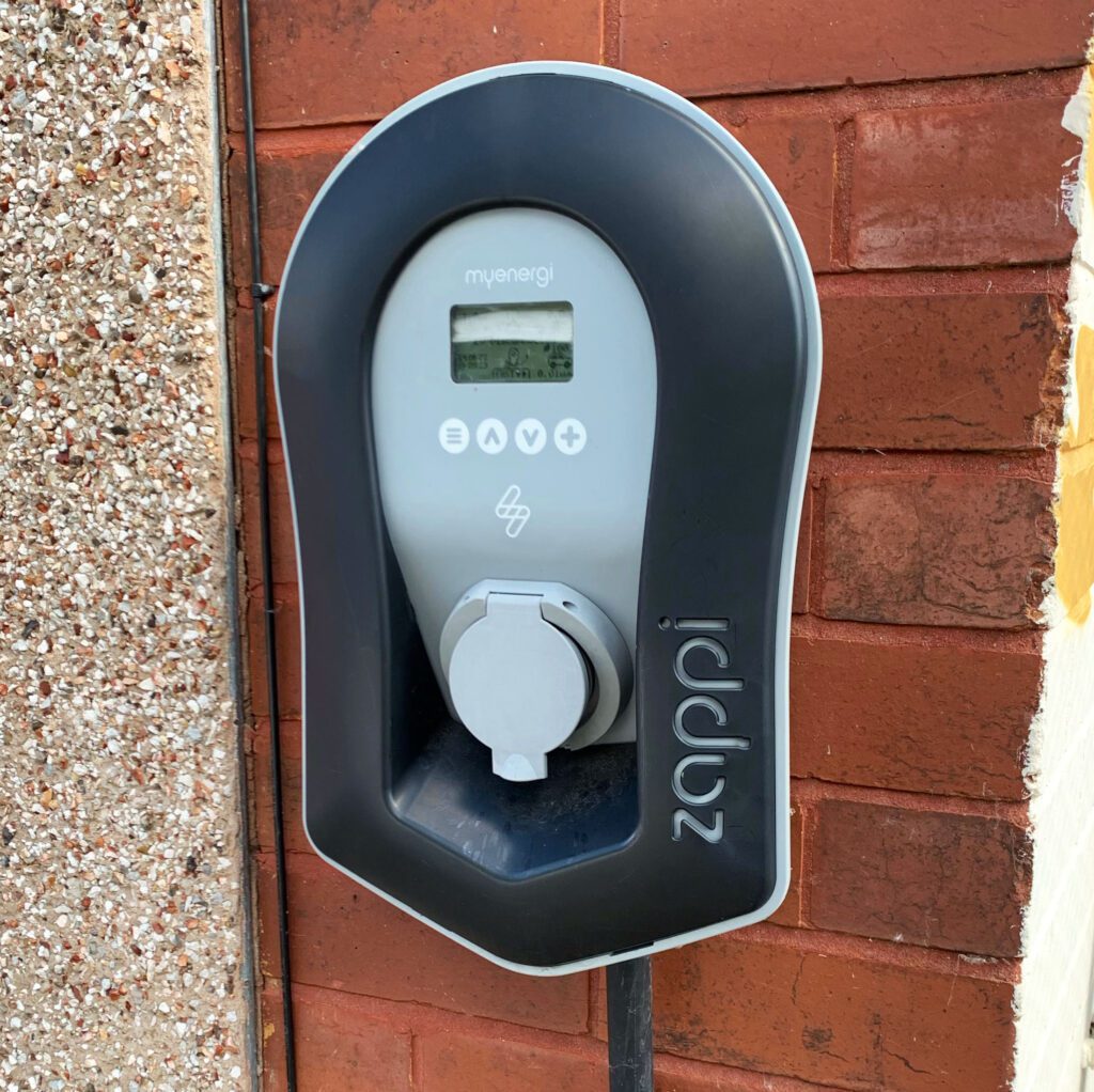 Zappie EV Charger installed on a wall on he side of a building