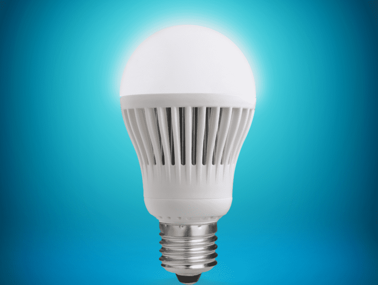 White LED bulb with ribbed body for heat dissipation, metallic base, and blue gradient background.