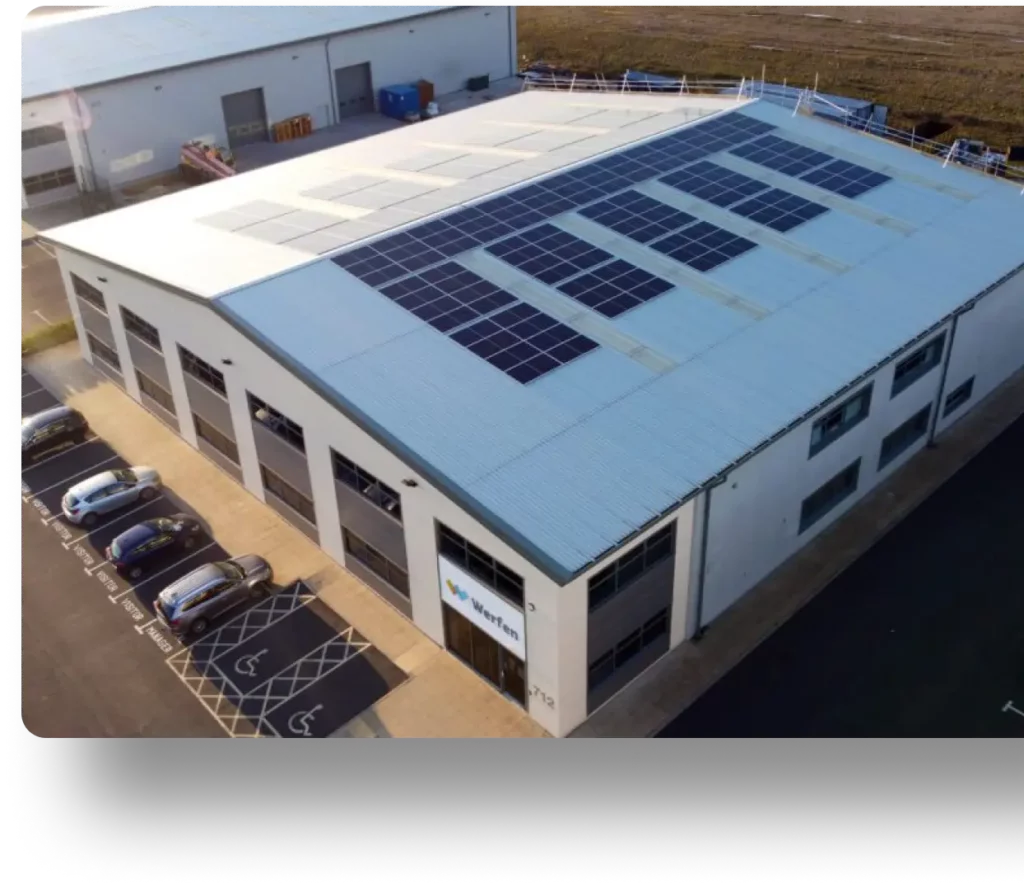 Aerial view of an industrial building with solar panels.