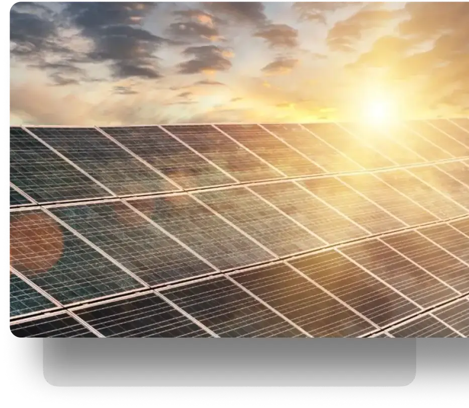 Solar panels in a vast grid under bright sunlight and a few clouds in the blue sky.