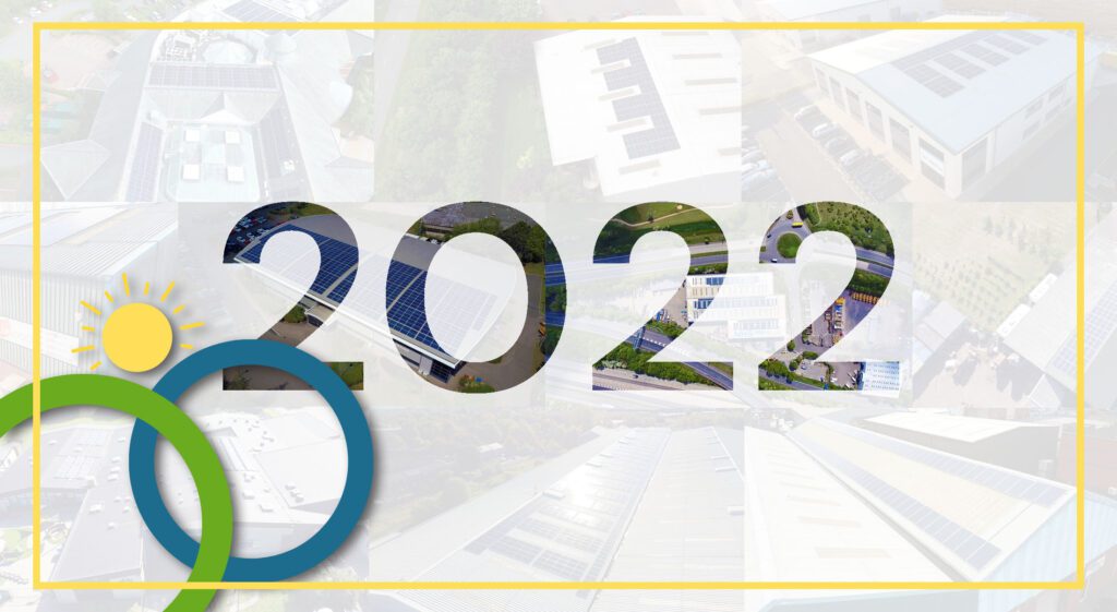 The year '2022' filled with images of solar panel-covered buildings, framed by energy-related symbols.