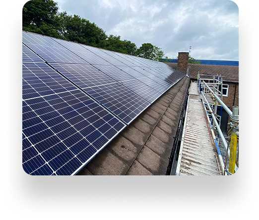Rooftop solar panels on an Alt Valley home cover a sloped roof. Scaffolding on the right and trees under a cloudy sky add to the serene scene.