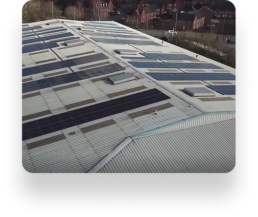 Rooftop near Lancs Farm covered with solar panels, surrounded by trees and charming homes, using sunlight for energy.