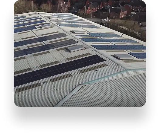 Rooftop near Lancs Farm covered with solar panels, surrounded by trees and charming homes, using sunlight for energy.