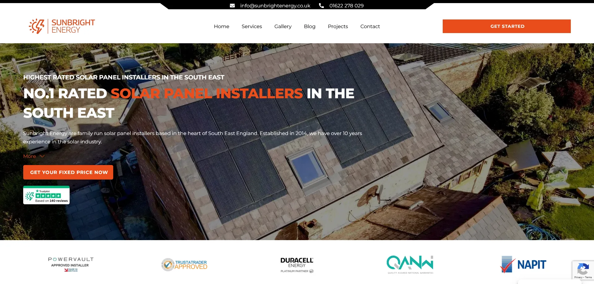 A homepage screenshot for Sunbright Energy, a solar panel installation company. The website highlights Sunbright Energy as the highest-rated solar panel installer in the South East of England. The header features the company’s name, logo, and navigation links. A central banner displays a tagline emphasizing their expertise, alongside a "Get your fixed price now" button for inquiries. The page includes certifications and partnerships such as Trustpilot, Powervault Approved Installer, Trustatrader Approved, Duracell Energy Platinum Partner, Quality Business National Membership, and NAPIT. In the background, an image of a house with solar panels on its roof is surrounded by greenery and other homes.
