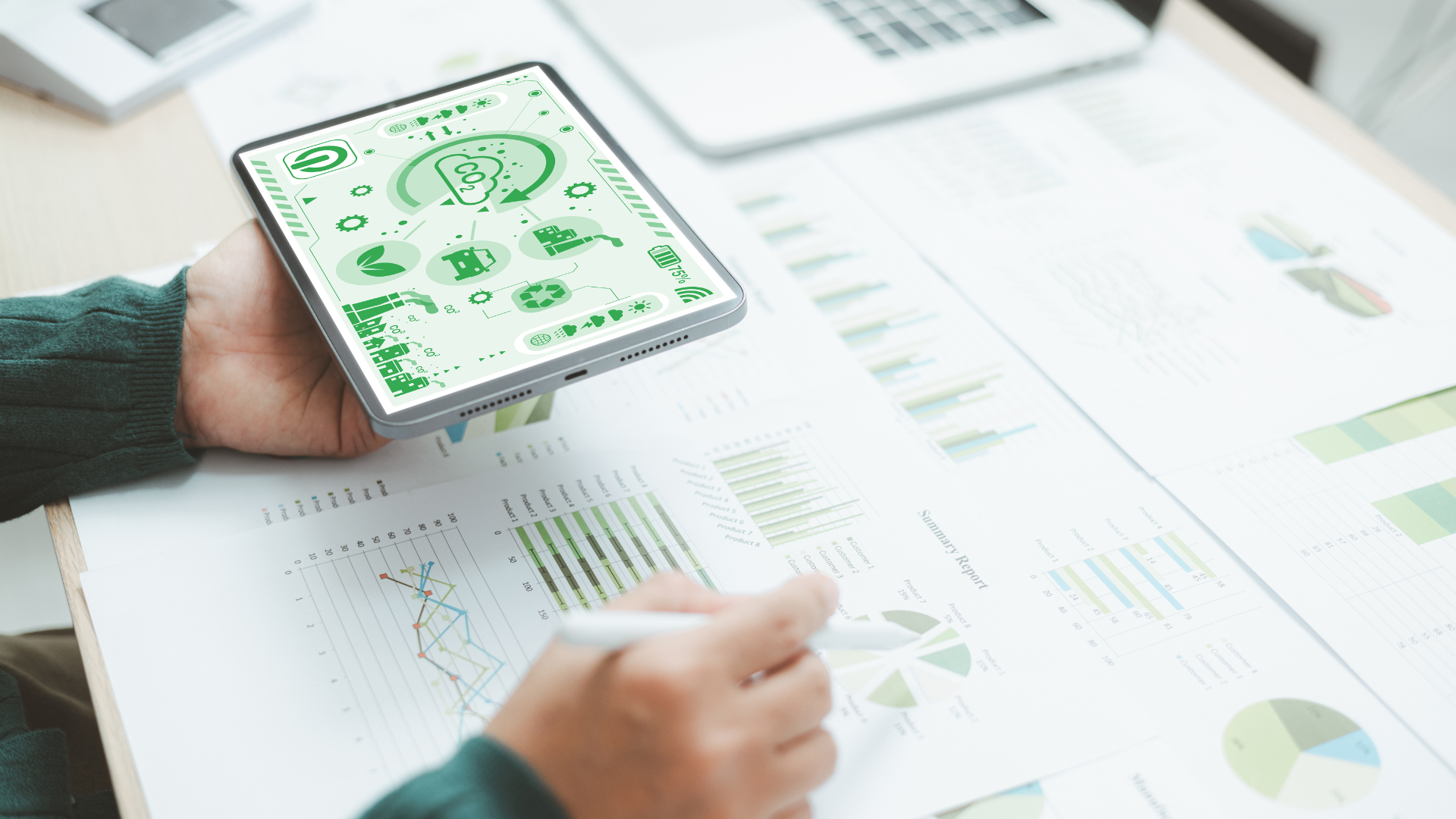 Person analyzing data on a tablet with graphs and charts