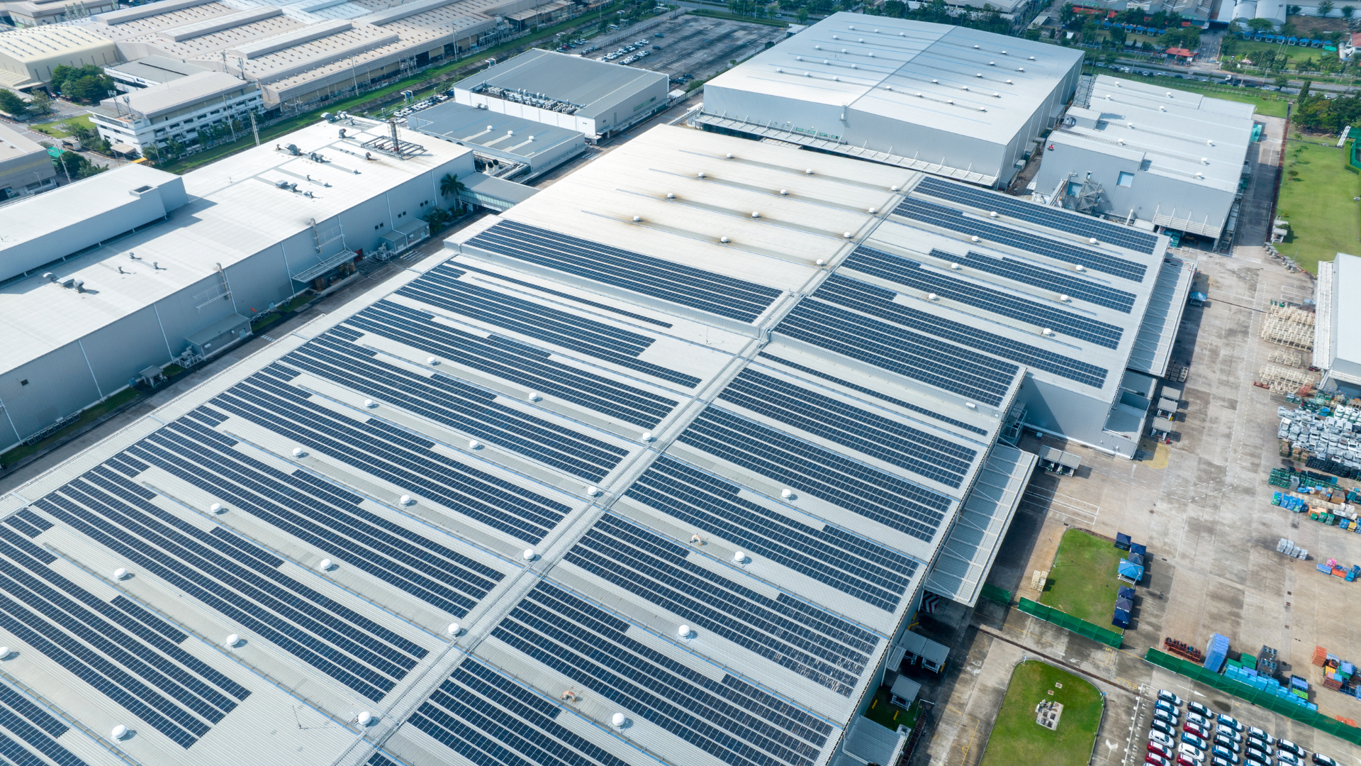 Infrastructure showcasing solar energy installation on factory rooftops.