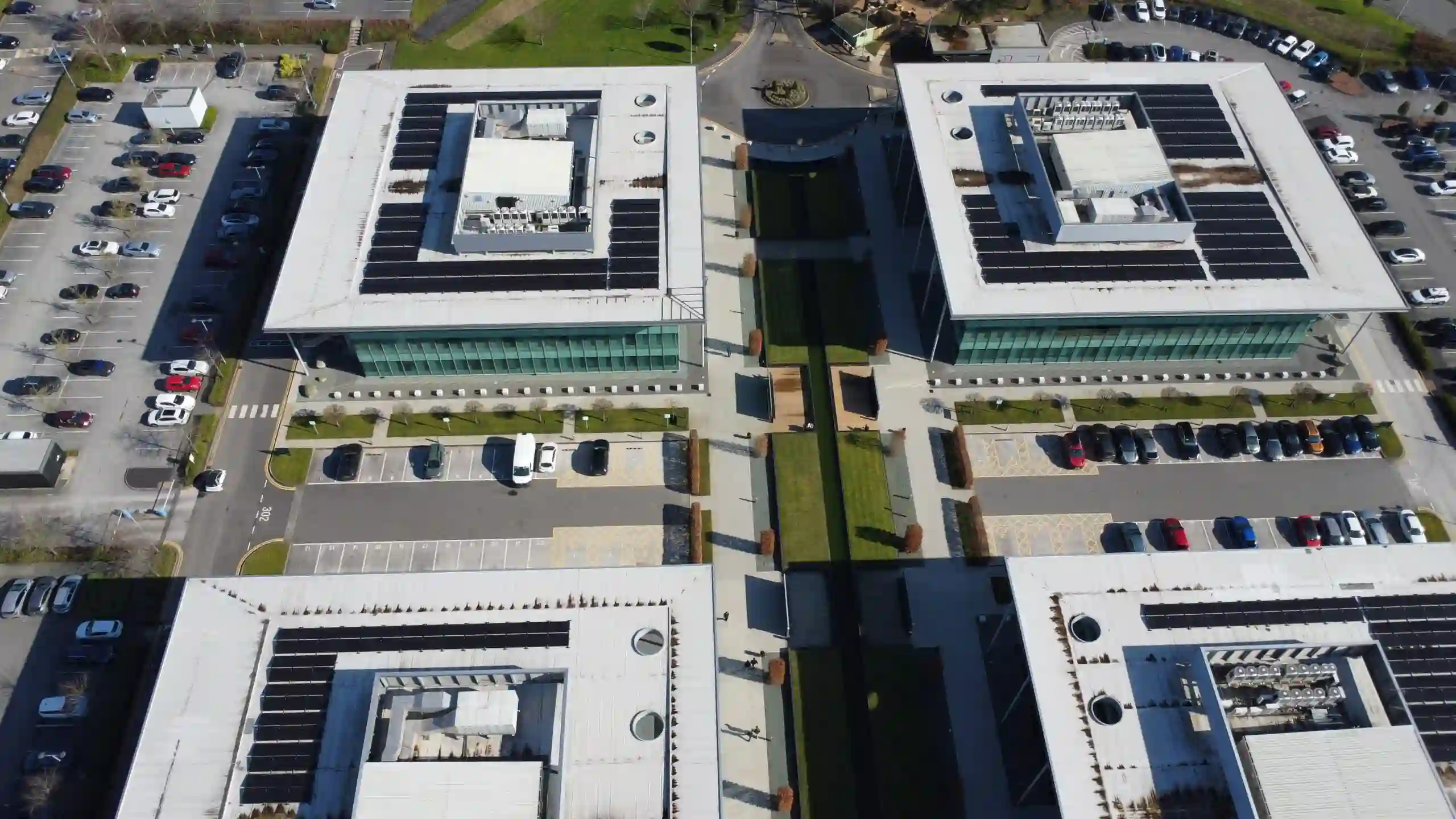 Aerial view of a modern office complex with solar panels.