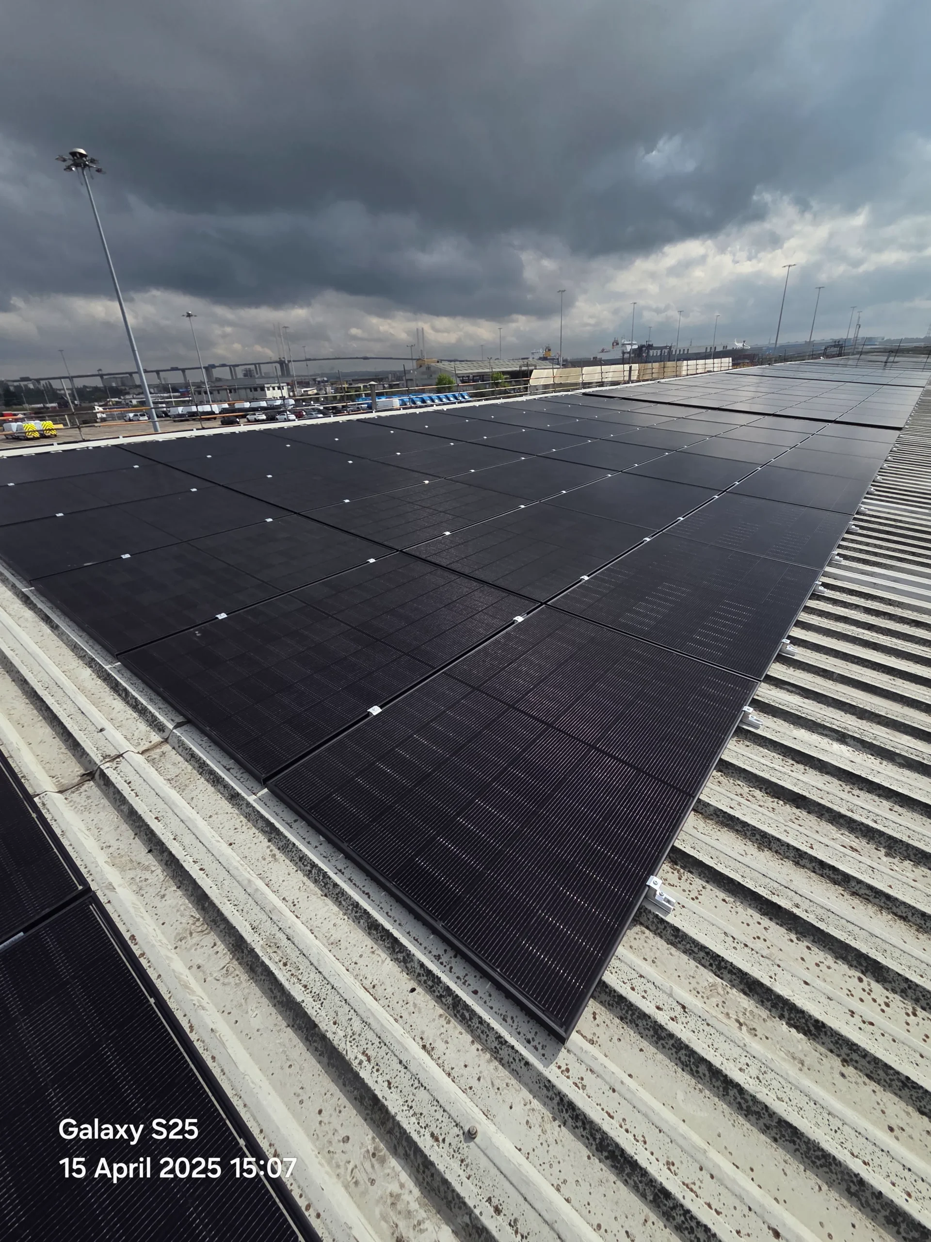 Rows of black solar panels on a CLdN warehouse roof